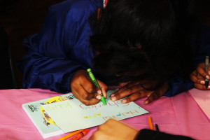 Child drawing in a book on children's day