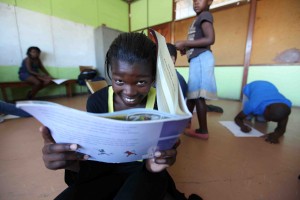 Child reading a book in a reading club