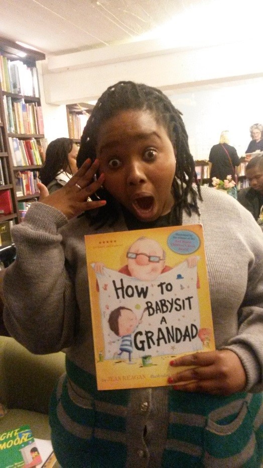 Our literacy mentor holding up "How to babysit a grandad" 