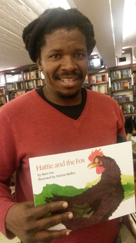 Our literacy mentor holding up the children's book "Hattie and the Fox"