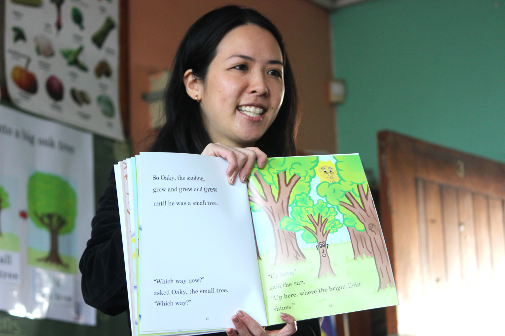 Taryn Lock reading a book at Cascade Primary School