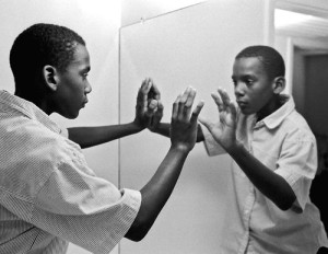 Boy looking at himself in the mirror