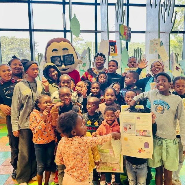 What a magical day of stories and smiles! 

As part of the Amazwi South African Museum of Literature and the Department of Sport, Recreation, Arts and Culture Eastern Cape LitFest programme at the National Arts Festival in Makhanda, children were captivated by unforgettable storytelling from Dr Gcina Mhlophe and our beloved mascot, Mfundo, while Phumeza Macwili brought stories to life with energy, imagination, and fun.

Our Reading Corner was buzzing with excitement as children explored bookmaking, enjoyed read-aloud sessions, and discovered the joy of reading through our supplements.

Every story shared, every page turned, and every smile reminded us that reading has the power to inspire, connect, and spark young imaginations. 

#Nalibali #Storytelling #ReadingForEnjoyment #NationalArtsFestival #LitFest